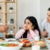 Parent helping a picky eater explore healthy foods at family mealtime