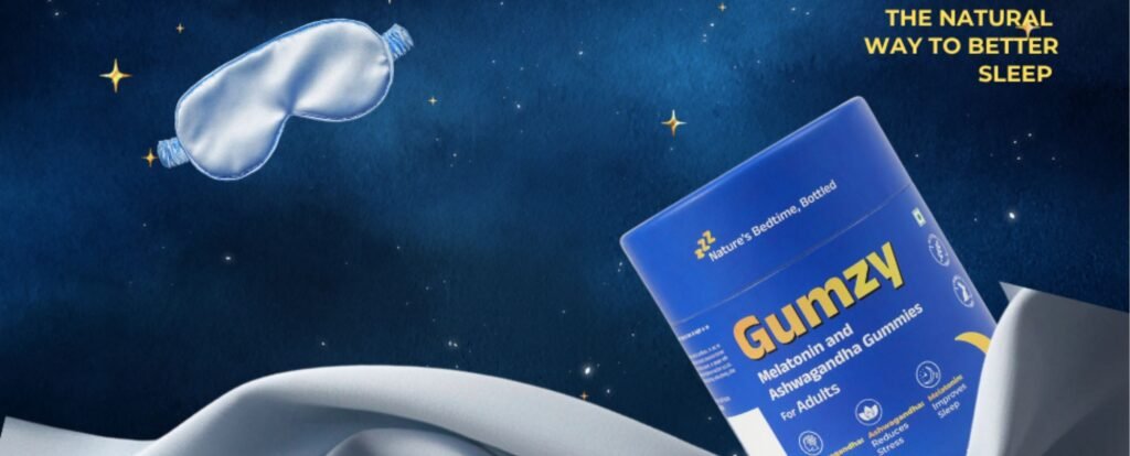Gumzy Melatonin and Ashwagandha Gummies box floating against a starry night sky with a satin sleep mask, alongside white bedding sheets, with text reading 'The Natural Way to Better Sleep