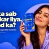 Smiling woman in pajamas holding a bottle of Gumzy Melatonin and Ashwagandha sleep gummies against a starry night background, featuring the text "Kal ka sab plan kar liya. Neend ka?".