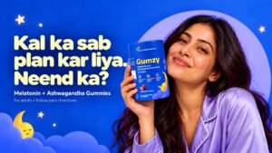 Smiling woman in pajamas holding a bottle of Gumzy Melatonin and Ashwagandha sleep gummies against a starry night background, featuring the text "Kal ka sab plan kar liya. Neend ka?".